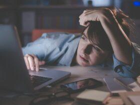 Sleepy woman working with her laptop