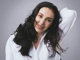 Beautiful middle aged woman wearing white shirt in photo studio